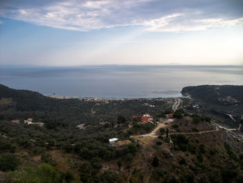 High angle view of townscape by sea against sky
