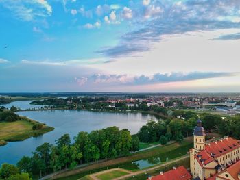 High angle view of river by buildings in city against sky