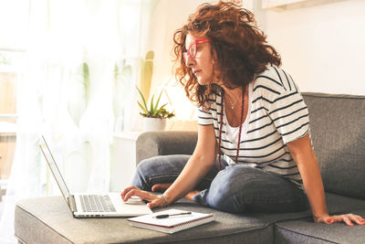 Woman using mobile phone at home