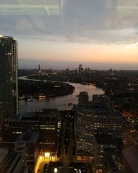 High angle view of illuminated buildings against sky during sunset