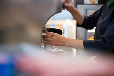 Midsection of man working with coffee