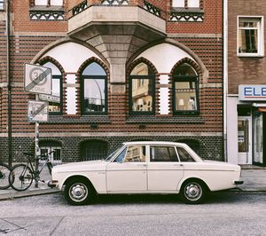 Car on street against buildings in city