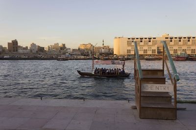 Boats in sea against buildings in city