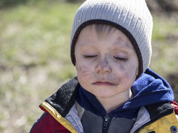 Close-up of boy with soot smear on face