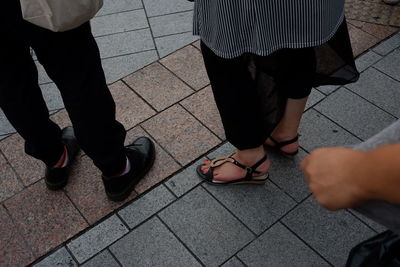 Low section of people standing on footpath