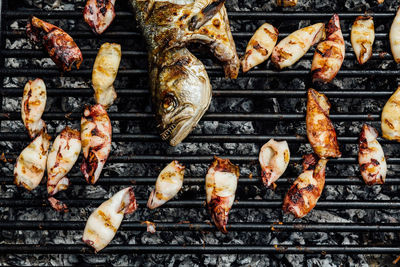 High angle view of meat on barbecue grill