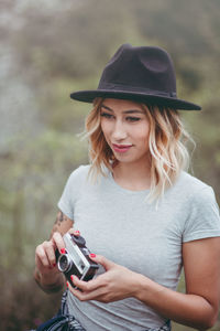 Portrait of young woman photographing