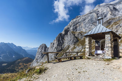 Built structure on mountain against blue sky