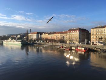 City by river against sky