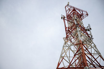 Low angle view of communications tower against sky