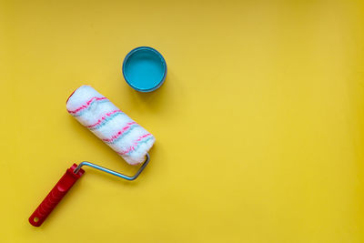 High angle view of colored pencils on yellow background