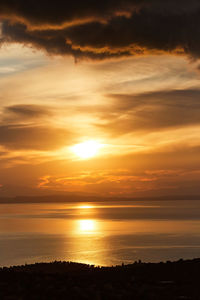 Scenic view of sea against romantic sky at sunset