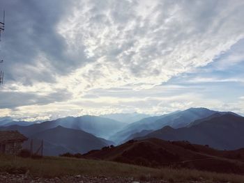 Scenic view of mountains against cloudy sky