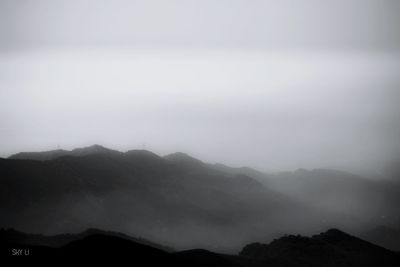 Scenic view of silhouette mountains against sky