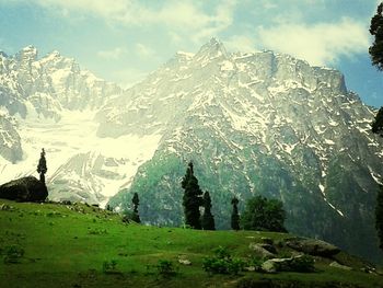 Scenic view of mountains against cloudy sky