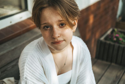 A candid snapshot captures a redhead teen's charisma, her short hair highlighting her playful spirit