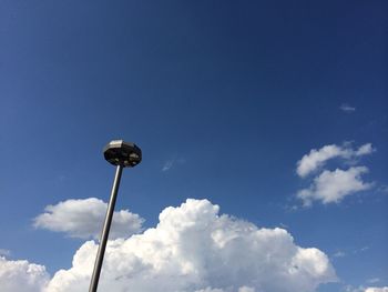 Low angle view of street light against blue sky