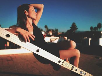 Woman sitting on ladder