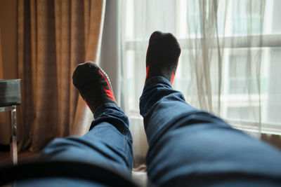 Low section of man relaxing at hotel