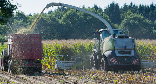 Agricultural machinery spraying grains at farm