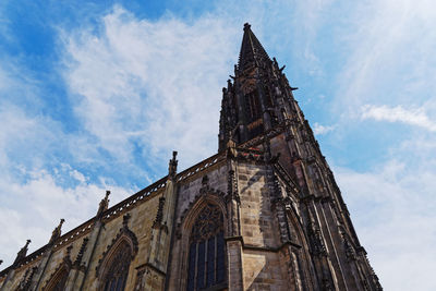 Low angle view of st lambert church against blue sky