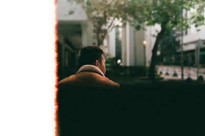 Rear view of man looking at city buildings