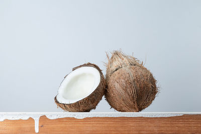 Close-up of bread on table against white background