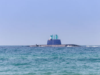 Ship sailing in sea against clear sky