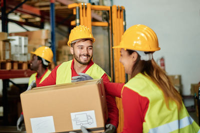 Smiling warehouse worker with clipboard