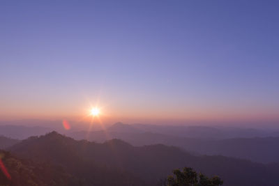 Scenic view of silhouette mountains against sky at sunset