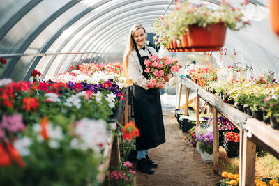 Woman standing in a greenhouse