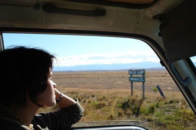 Side view of woman in car