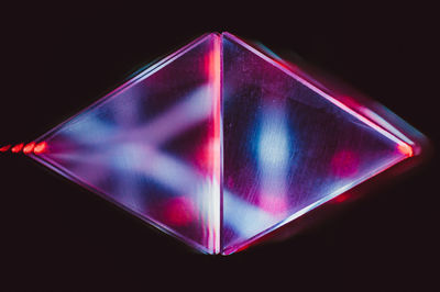 Close-up of illuminated lighting equipment against black background