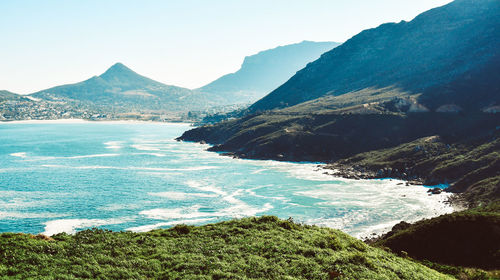 Scenic view of sea and mountains against sky