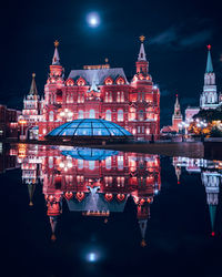 Reflection of illuminated buildings in city at night