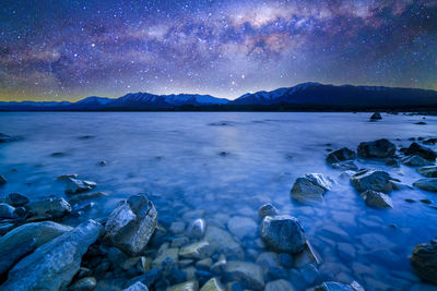 Scenic view of sea against sky at night