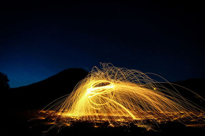 Light trails against sky at night