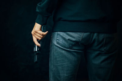 Midsection of man holding smart phone