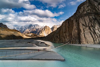 Scenic view of lake by mountains against sky