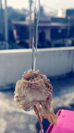 Close-up of hand holding ice cream