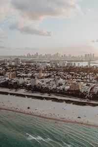 High angle view of buildings by sea against sky