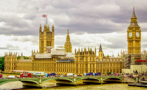 View of clock tower bridge against cloudy sky