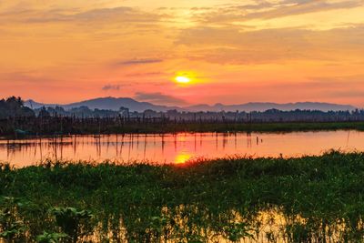 Scenic view of lake against romantic sky at sunset