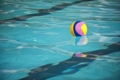 Colorful ball floating in swimming pool