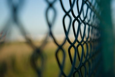 Close-up of chainlink fence against sky