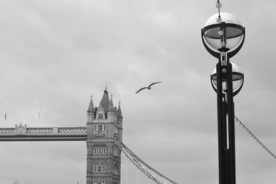 Low angle view of clock tower against cloudy sky