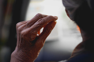 Close up of senior women raised fist outdoors