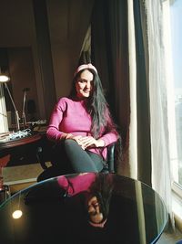 Girl sitting on chair peacefully  seeing outside view from window