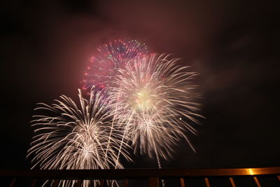 Low angle view of firework display at night