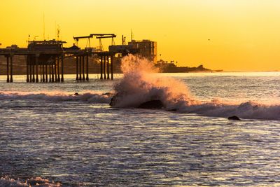 Scenic view of sea against clear sky during sunset